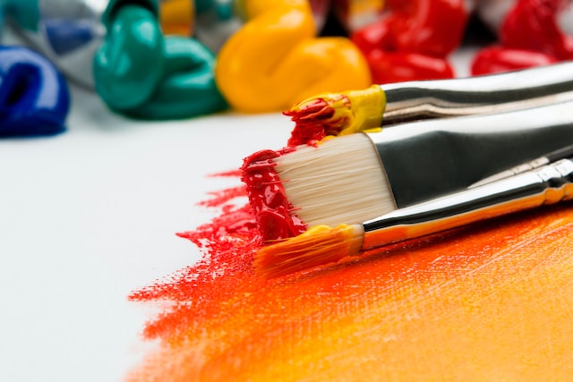 Paint brushes with red and yellow paints