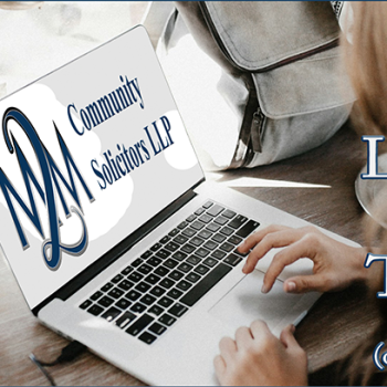 Free legal talks on Zoom with M2M Solicitors LLP - image shows a woman using a laptop.