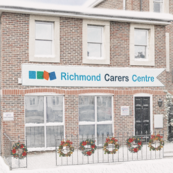 Richmond Carers Centre under snow with a Christmas tree and Santa tending to his reindeer