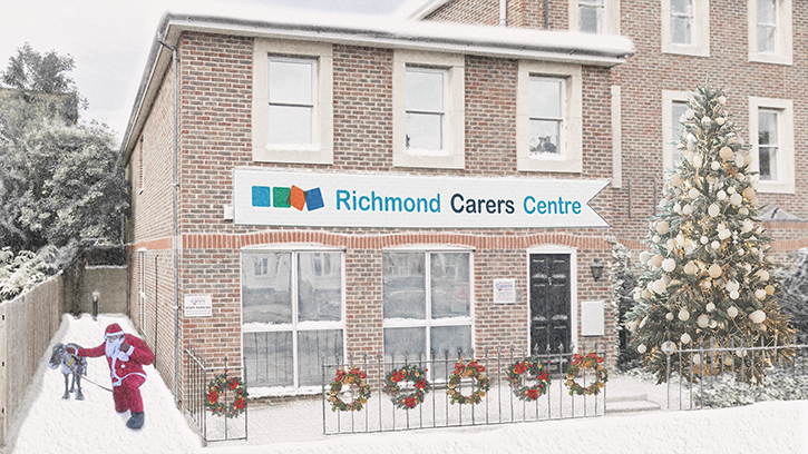 Richmond Carers Centre under snow with a Christmas tree and Santa tending to his reindeer