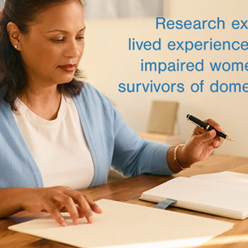 Research exploring the lived experience of visually impaired women who are survivors of domestic abuse from a male partner banner. A shot of a visually impaired woman whose hands are resting on a desk. One hand is gently touching a page of tactile Braille text, while the other holds a classic fountain pen over a blank journal. Soft, natural sunlight streams from the side, creating gentle shadows.