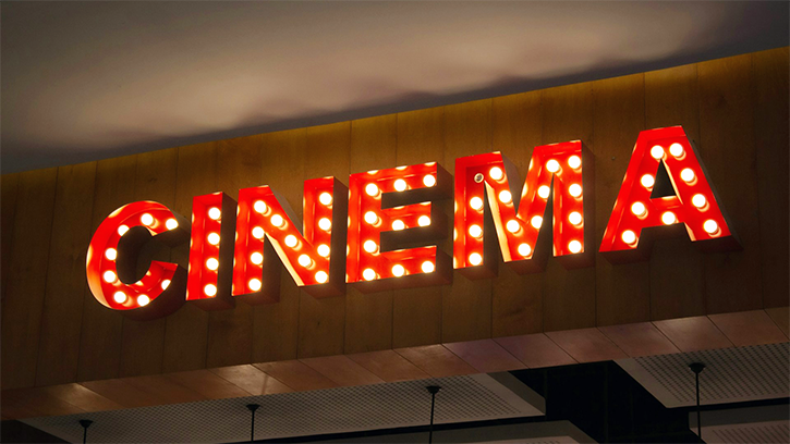 The word CINEMA in red and white glowing lights