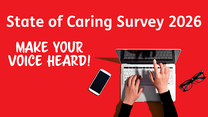 Carers UK - State of Caring 2026 survey. Image of hands typing on a laptop with a mobile phone and glasses to the side of the laptop. Image presented on a bright red background.