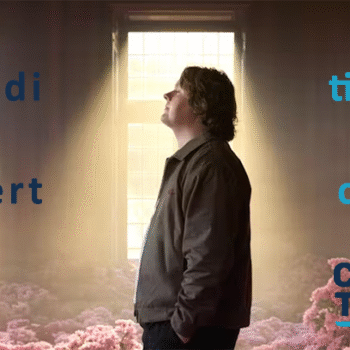 Lewis Capaldi concert for carers banner. Image shows Lewis Capaldi standing in a dimly lit room surrounded by pink flowers