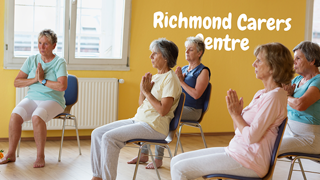 Meditation Group Session – Pause and Reset. Group sitting around a room in a meditative pose.