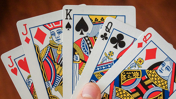 A closeup of a winning poker hand of a king, two queens and two jacks
