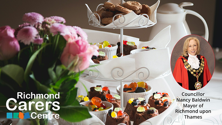 Beautiful afternoon tea stack with a teapot in the background, sweet treats held on the plate above and small cakes to top-off the display