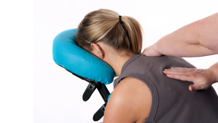Carer sits in massage chair with shoulders being rubbed